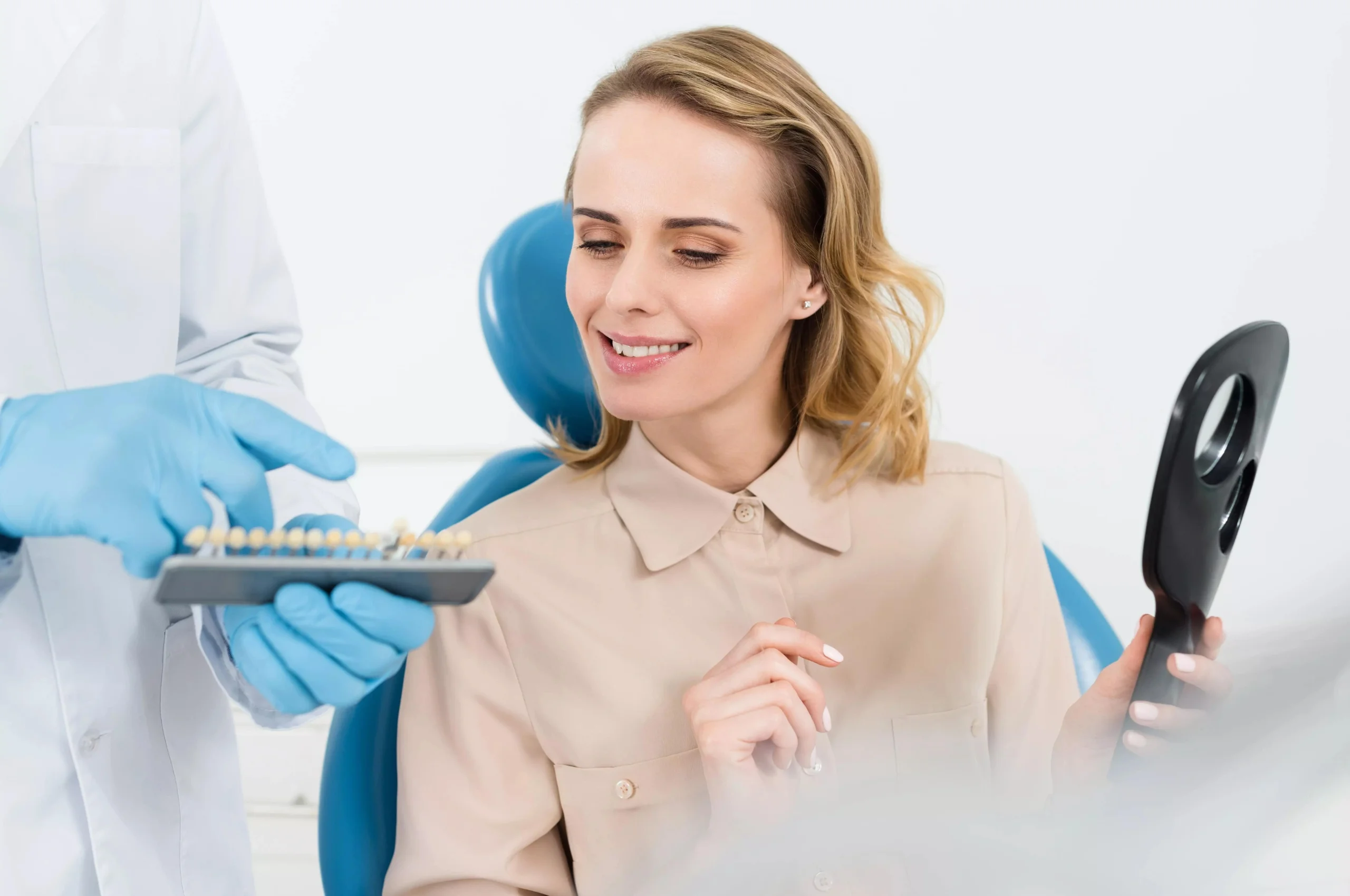 Dentist showing tooth implants to female patient