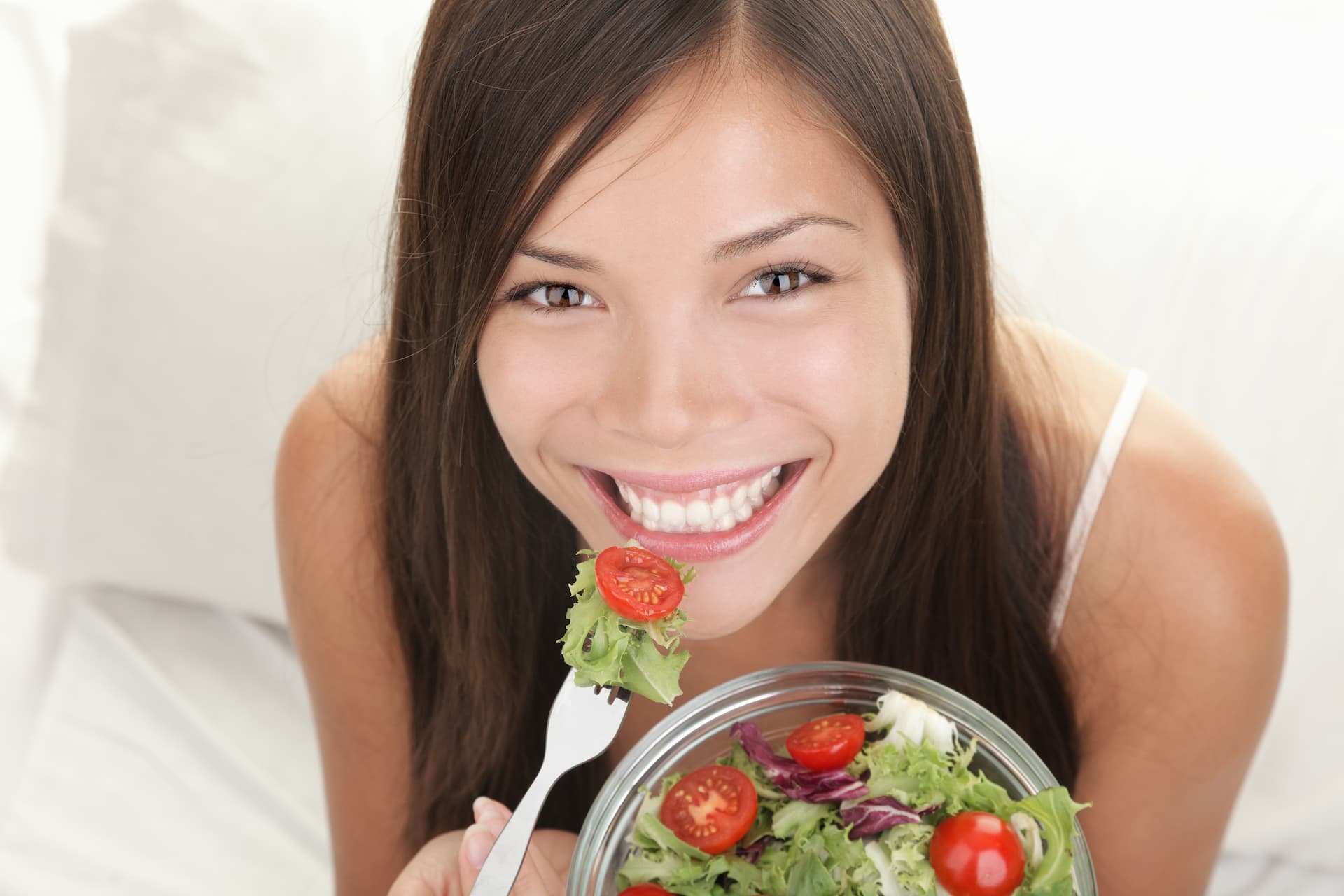 confident woman eating salad