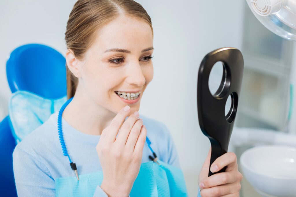 woman looking at her teeth in the mirror