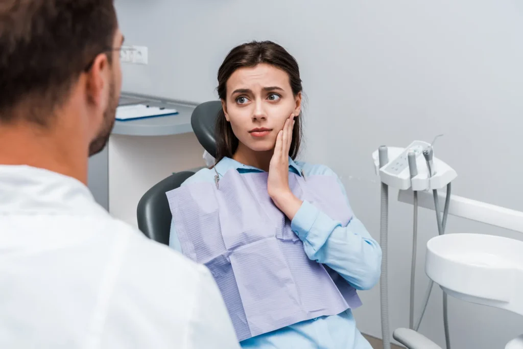 woman with toothache consulting a dentist